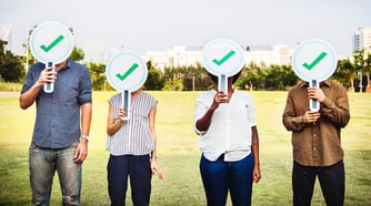 Canva - Four People Holding Green Check Signs Standing on the Field Photography