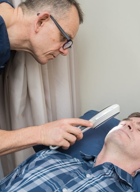 Doctor performing skin check